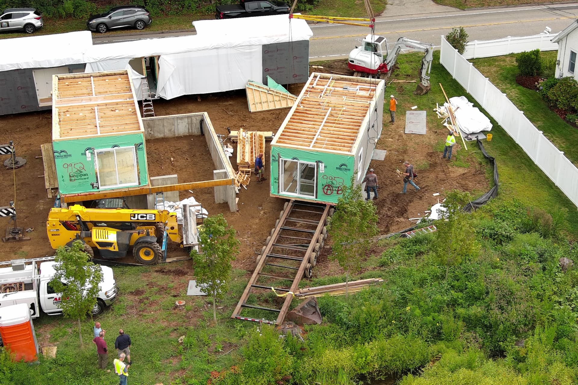 Two modular home modules staged on carriers before being craned into place in Hartford County, Connecticut